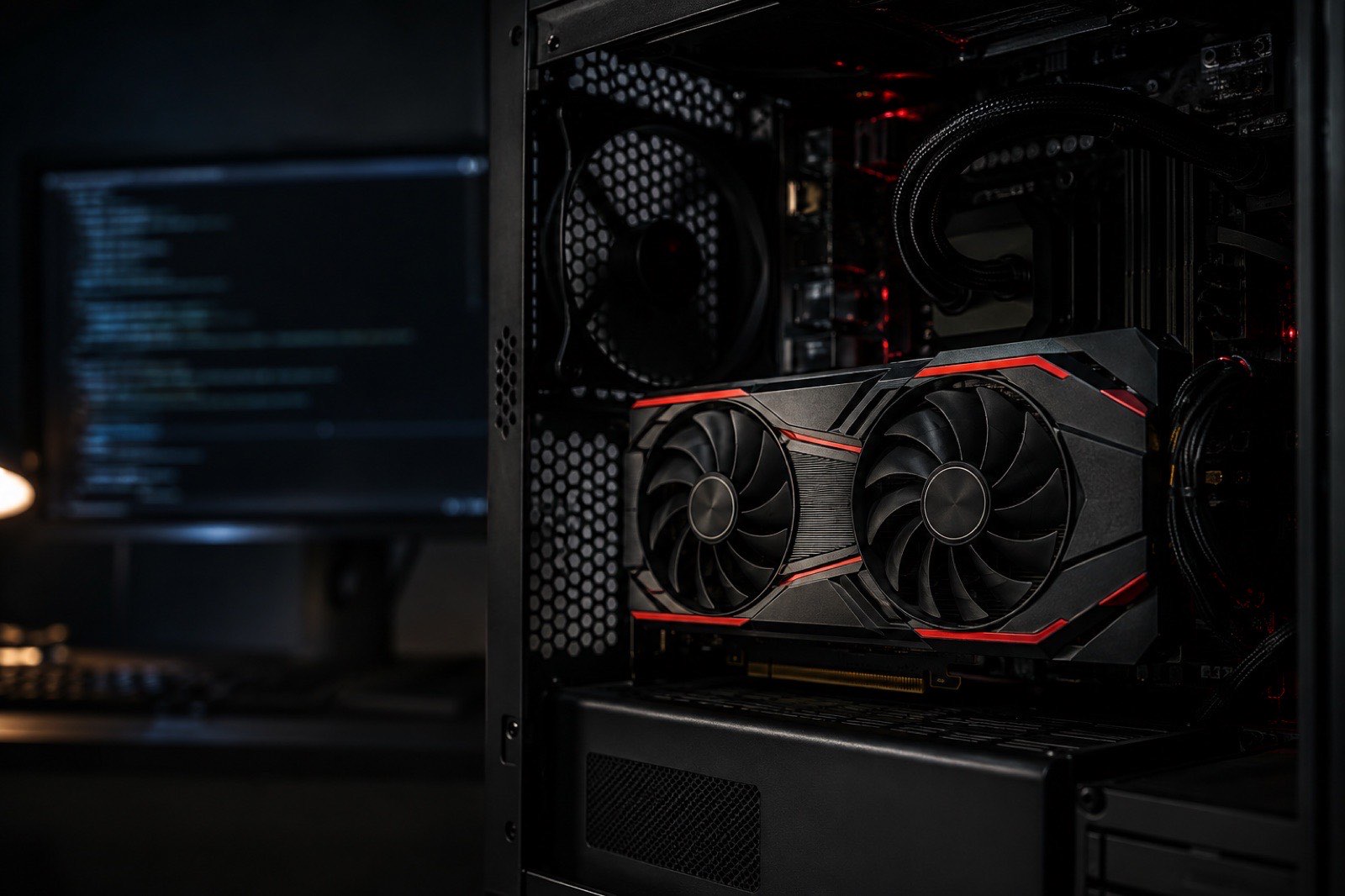 Illustration: a red-accented graphics card in an open workstation, a blurred terminal window glowing on the monitor behind